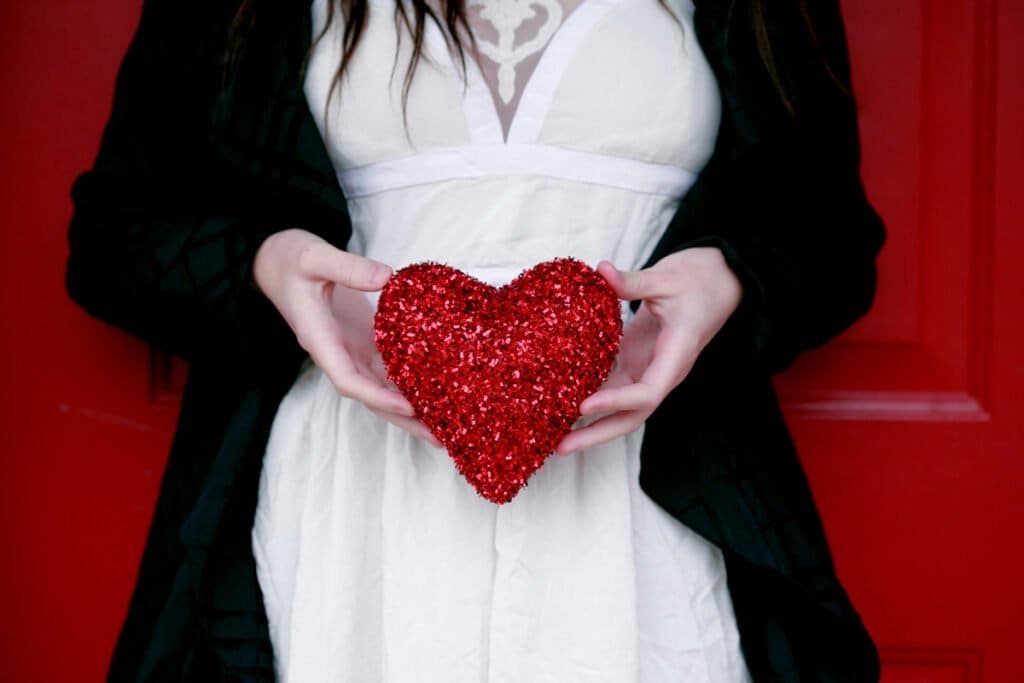 woman holding a red valentines heart