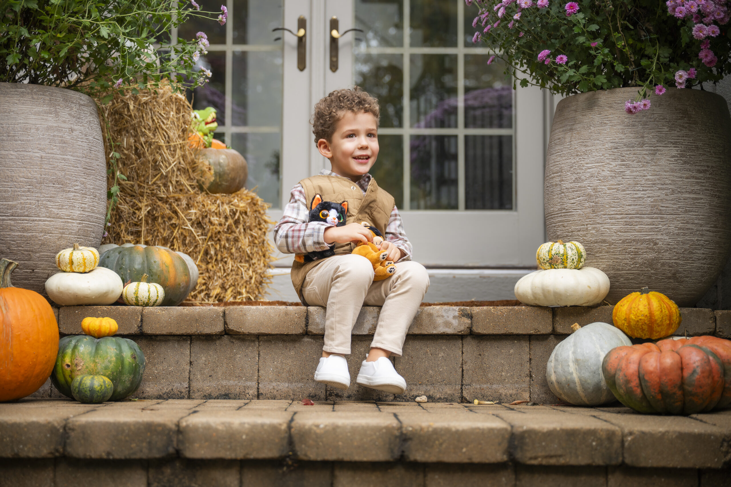 photo of boy sitting outside his home